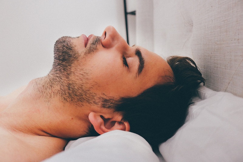 CBD Oil for Sleep Close Up of a Man's Head While He Sleeps on a Pillow