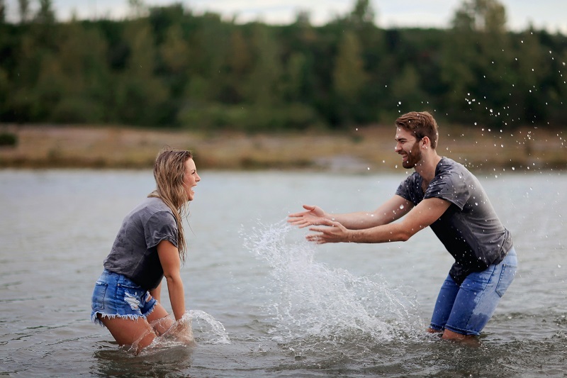 How Will CBD Oil Affect Me Couple Splashing Each Other Outdoors in a Small Lake