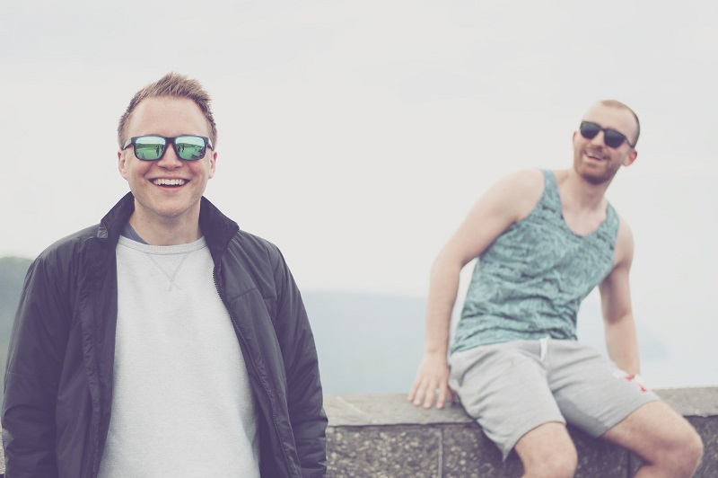 CBD for Pain Two Guys Outdoors on a Cloudy Day Wearing Sunglasses