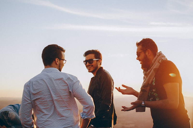 How do I use CBD A Group of Friends Talking and Laughing Outdoors During Sunset