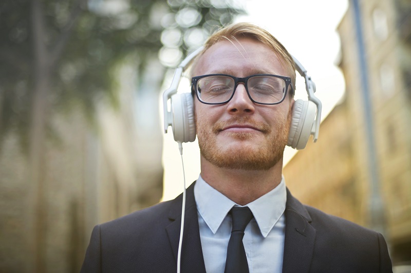 How do I use CBD Close Up of a Man in a Suit Listening to Music Using Headphones