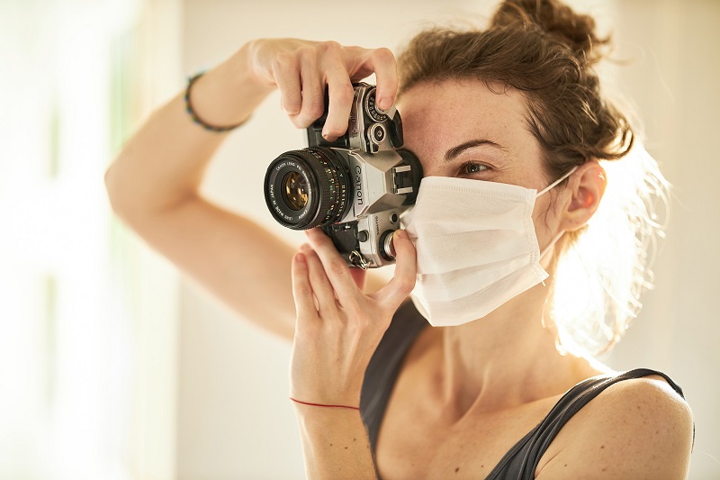 CBD has Potential to Help Prevent COVID-19 Infection Woman Taking a Picture While Wearing a Face Mask