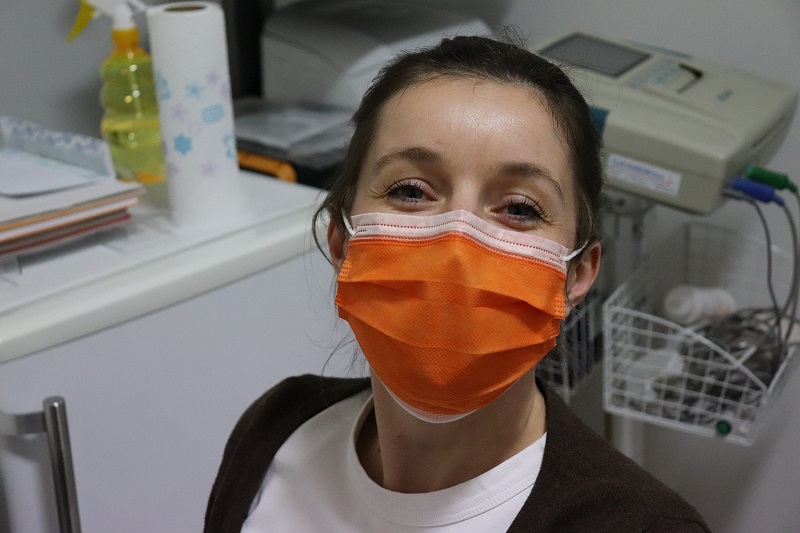 CBD has Potential to Help Prevent COVID-19 Infection Woman Posing for a Picture Wearing an Orange Face Mask