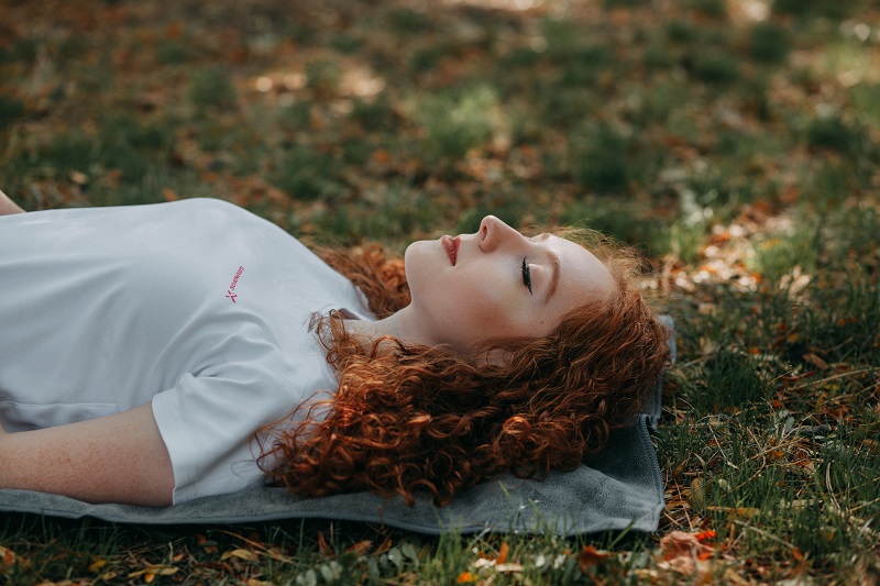 Clinical Studies of CBD to Improve Sleep Woman Sleeping on a Patch of Grass Outside