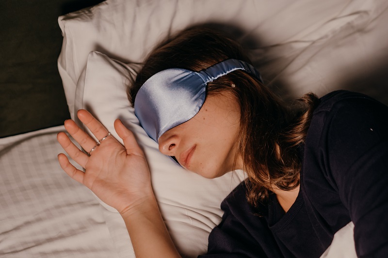 Clinical Studies of CBD to Improve Sleep Woman Sleeping in a Bed with a Blindfold On