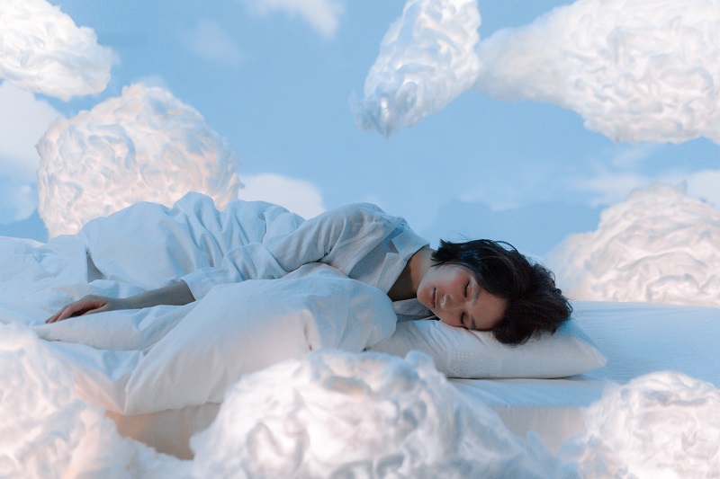 Clinical Studies of CBD to Improve Sleep Woman Sleeping on a Cloud Surrounded by Clouds