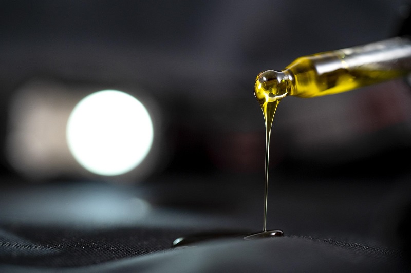Good Manufacturing Practices for CBD Close Up of a Dropper Pouring CBD Oil Out onto a Surface