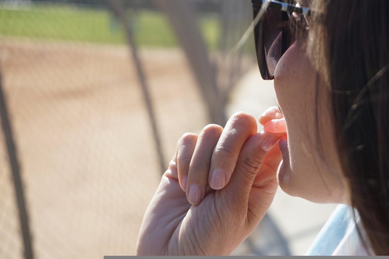 Bioavailability Close Up of a Woman Eating a Gummy