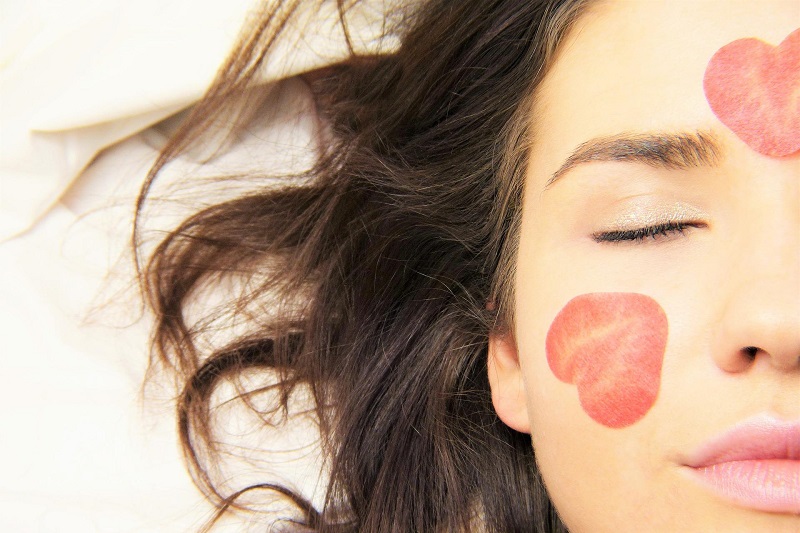What is Hemp Used for Medically Close Up of a Woman's Face with Her Eyes Closed and Rose Petals on Her Skin