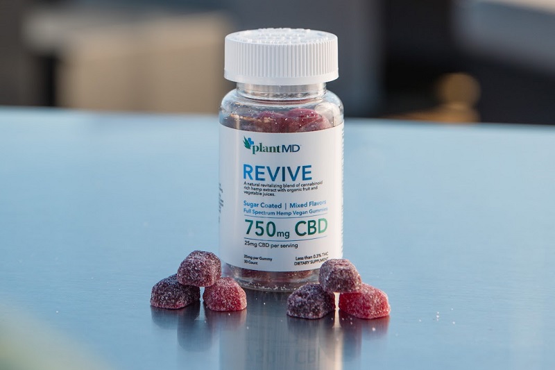 Where to Buy Revive CBD Gummies Close Up of PlantMD Revive Gummies on a Reflective Surface