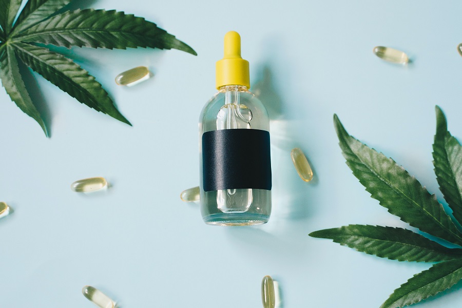 Why PlantMD CBD is the Best Value an Unmarked Bottle of CBD Oil Surrounded By Capsules and Hemp Plant Leaves