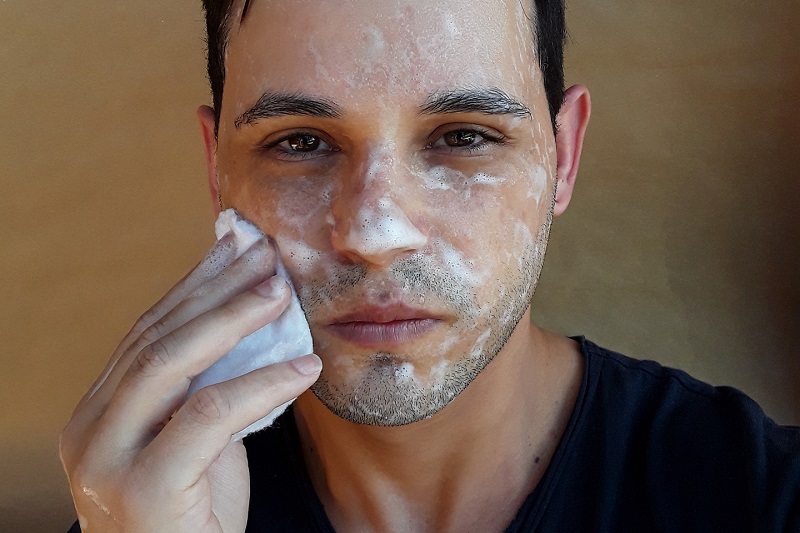 CBD Oil Benefits for the Skin Close Up of a Man Washing His Face with Soap and Water