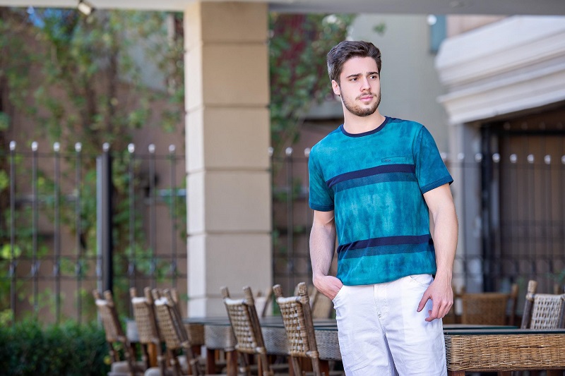 Can CBD Help with Hair Growth Man Standing Outside in Front of a Restaurant with a Patio for Seating