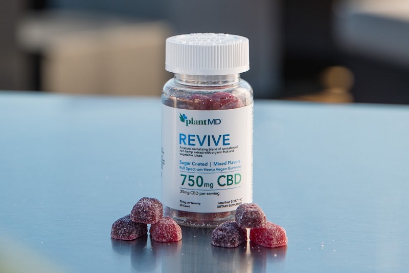 Difference Between CBD Isolate Gummies and Full Spectrum Gummies a Bottle of Plant MD Revive Gummies on a Reflective Surface