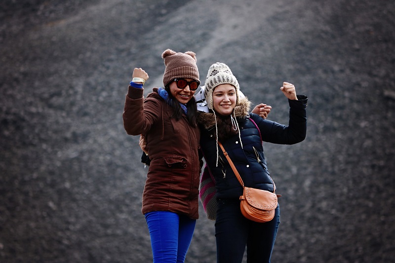 How CBD Helps with Periods Two Women Hiking in the Cold With Heavy Jackets On and Hats