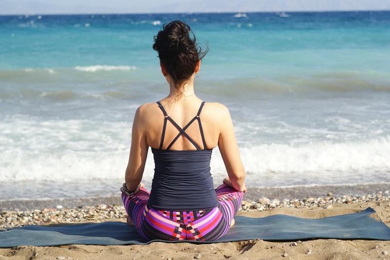 How to Use CBD for Meditation Woman Meditating on a Beach