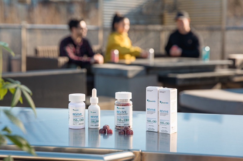 Why High-Quality Formulations Matter Most in CBD Products PlantMD Revive Products Sitting on an Outdoor Surface with People in the Background